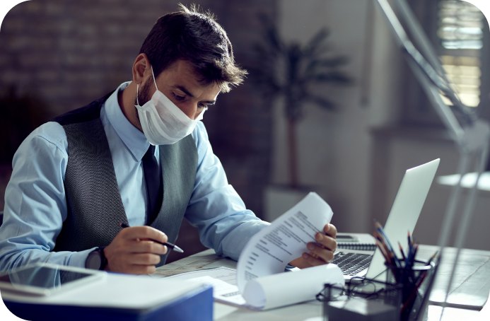 Billing specialist reviewing a paper claim at his desk