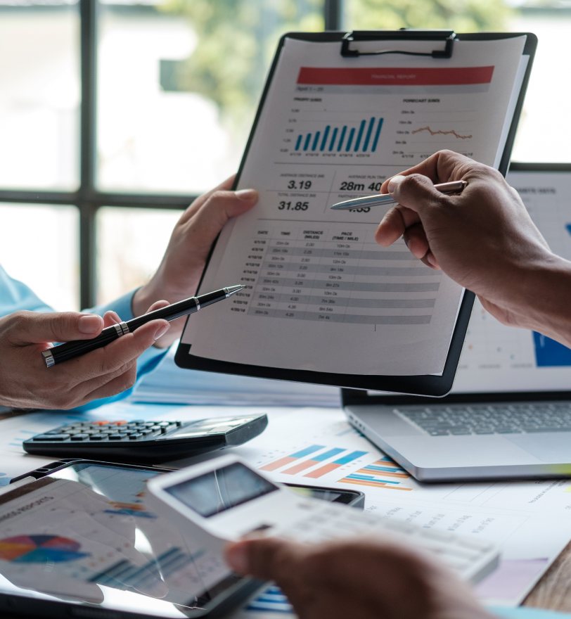 Practice owner and billing consultant comparing pricing figures on a report